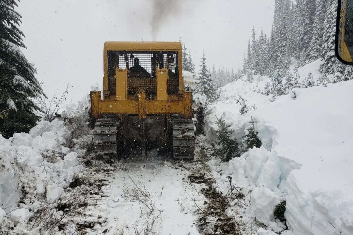 Dozer clearing a trail through deep snow