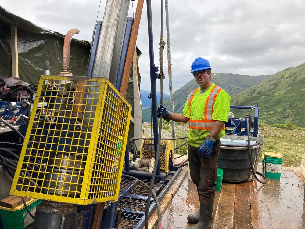 Driller at a drill on an alpine ridge